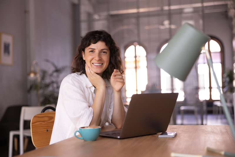 Woman at laptop doing email copywriting